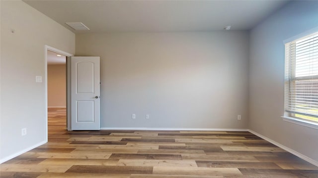 unfurnished room with light hardwood / wood-style floors