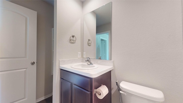 bathroom with vanity and toilet