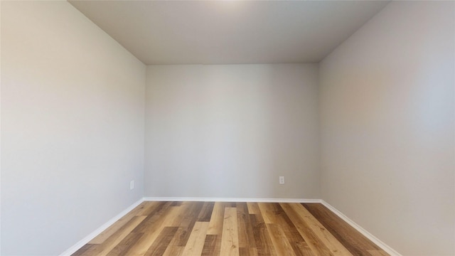 unfurnished room with wood-type flooring