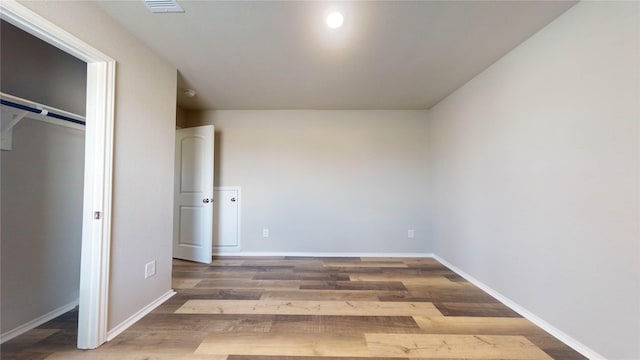 unfurnished bedroom featuring hardwood / wood-style flooring and a closet