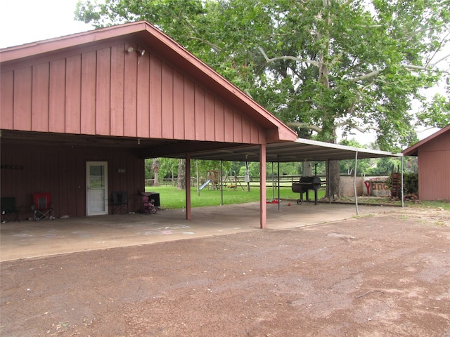 view of home's community with a playground and a carport