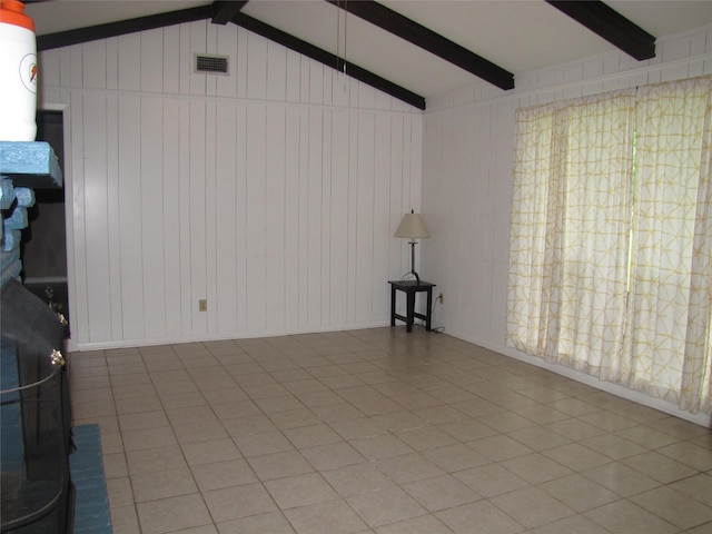 20002 Fm 1488th Rd, Magnolia, TX 77355 - unfurnished living room featuring lofted ceiling with beams, wooden walls, and visible vents