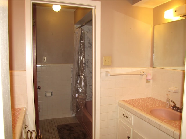 bathroom featuring tile walls, vanity with extensive cabinet space, tasteful backsplash, tile flooring, and shower / bath combo