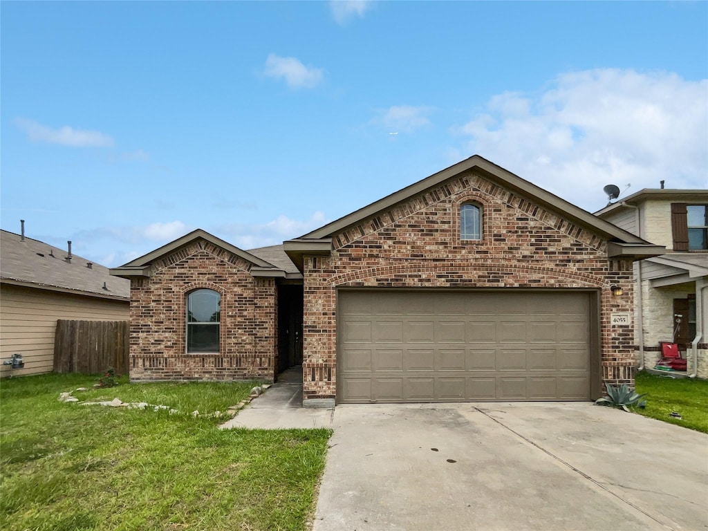 view of front facade with a garage and a front lawn