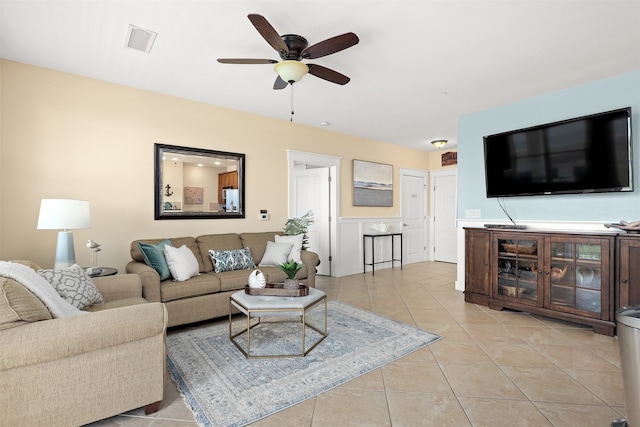 living room featuring light tile flooring and ceiling fan