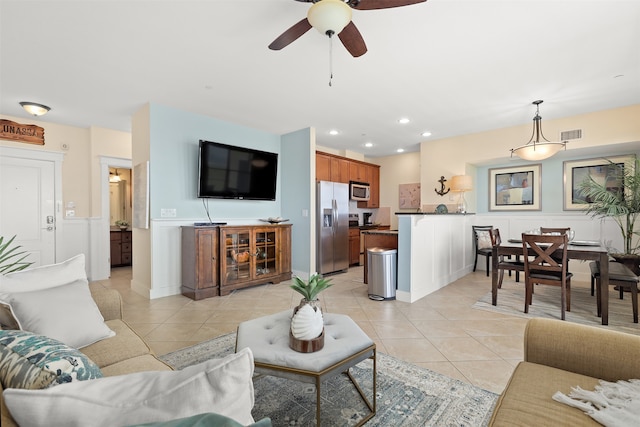 tiled living room featuring ceiling fan