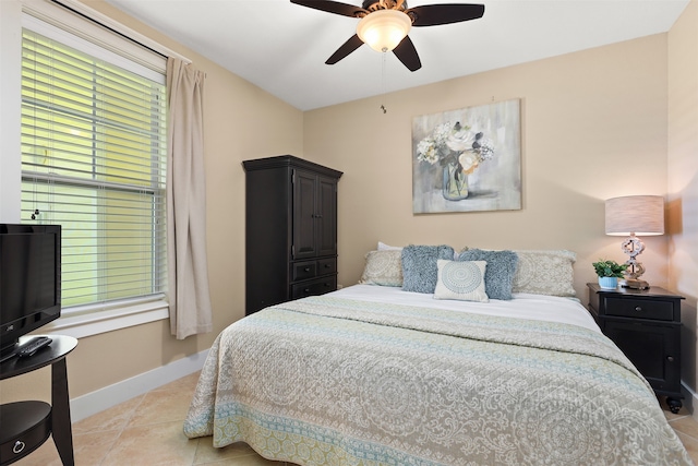 bedroom featuring ceiling fan and light tile floors