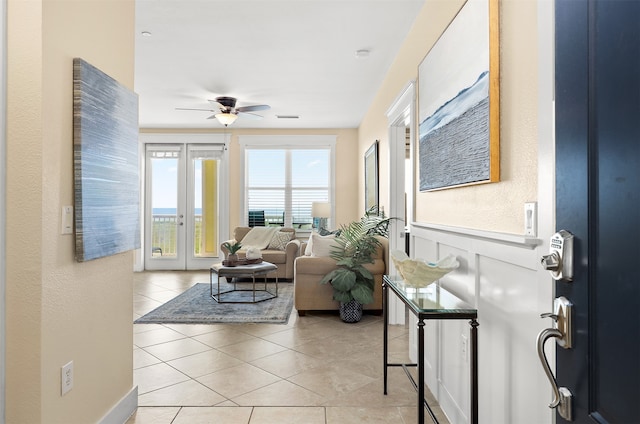 tiled living room with ceiling fan