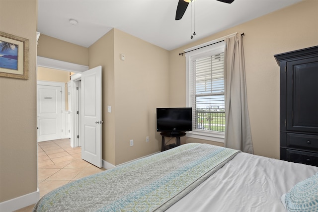 bedroom featuring ceiling fan and light tile floors