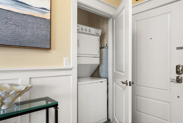 laundry area featuring stacked washer / dryer