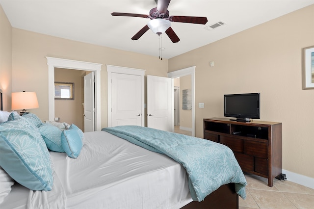 tiled bedroom featuring ceiling fan