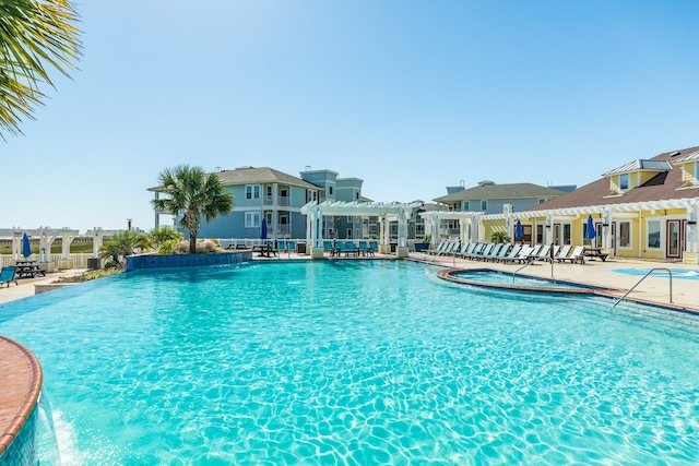 view of swimming pool with a patio area and a pergola