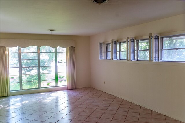 unfurnished room with tile patterned flooring