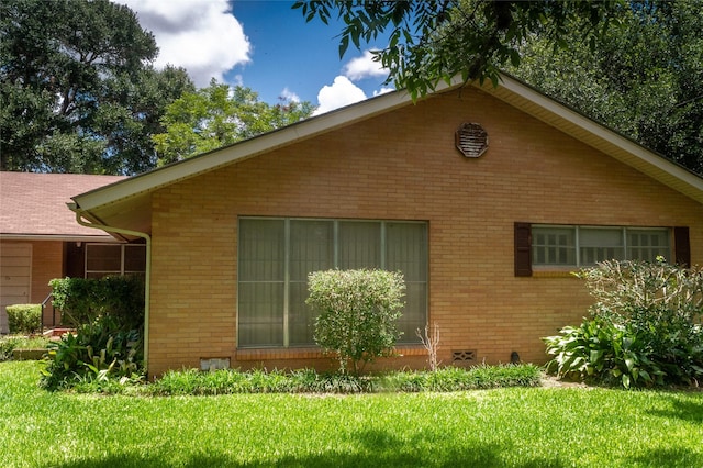 view of side of home with a lawn