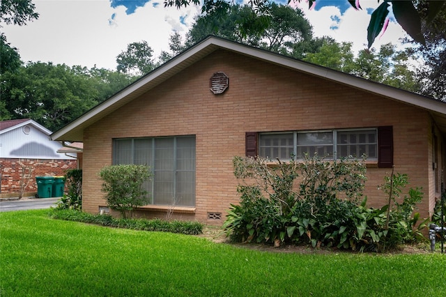 view of property exterior with a lawn