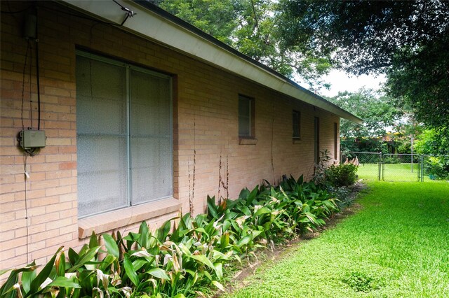 view of side of property with a lawn