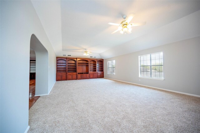 unfurnished living room featuring ceiling fan, lofted ceiling, and carpet floors