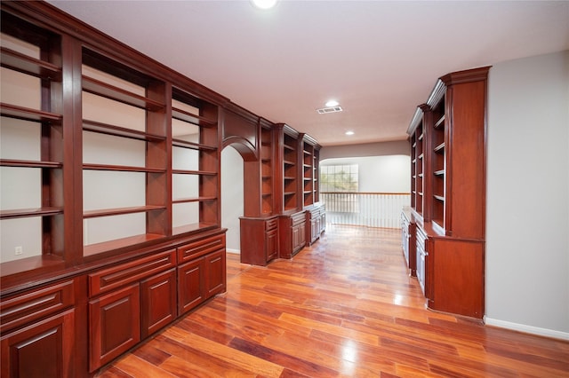 corridor with light hardwood / wood-style floors