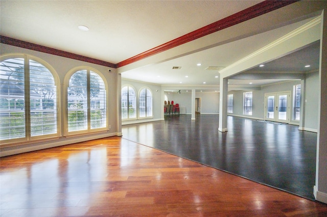 exercise room with hardwood / wood-style floors, french doors, and crown molding