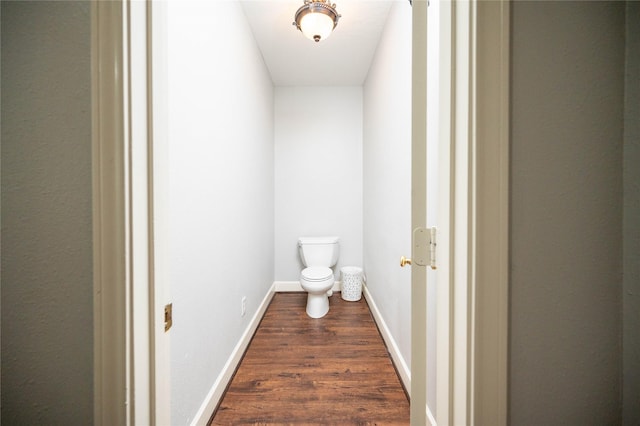 bathroom with hardwood / wood-style flooring and toilet