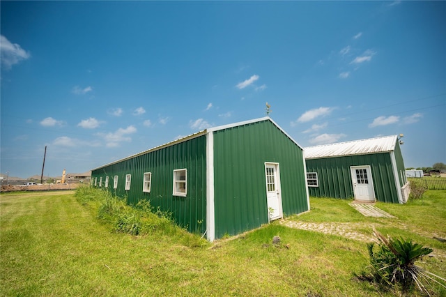 view of outbuilding featuring a yard