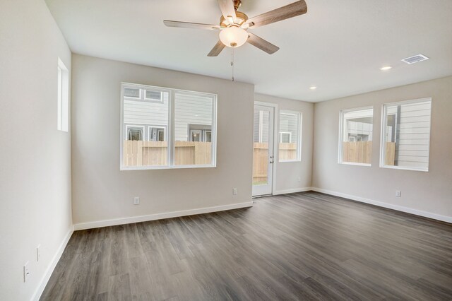 empty room featuring ceiling fan and dark hardwood / wood-style flooring