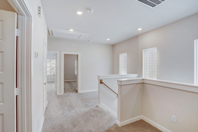 corridor with light colored carpet