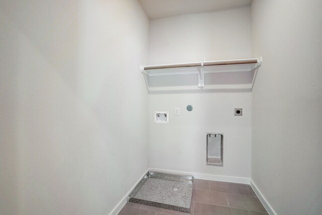 washroom with electric dryer hookup, hookup for a gas dryer, hookup for a washing machine, and dark tile patterned flooring