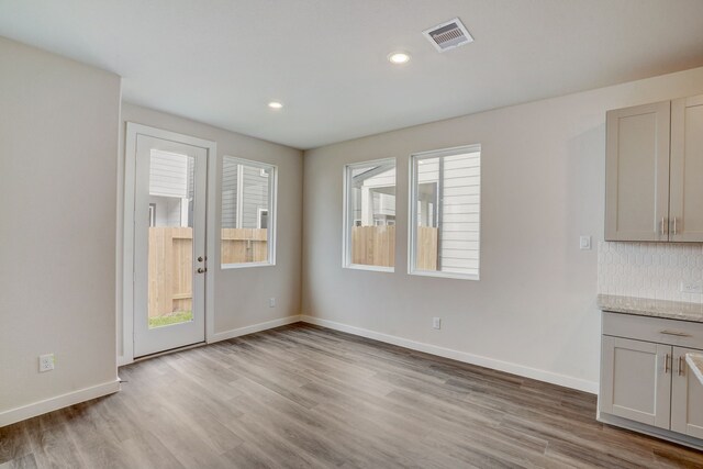 unfurnished dining area with light hardwood / wood-style flooring