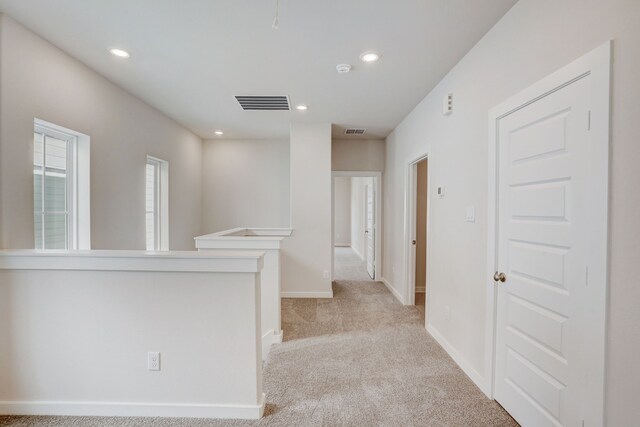 hallway with light carpet