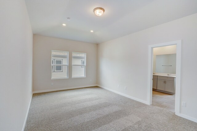 spare room featuring light colored carpet