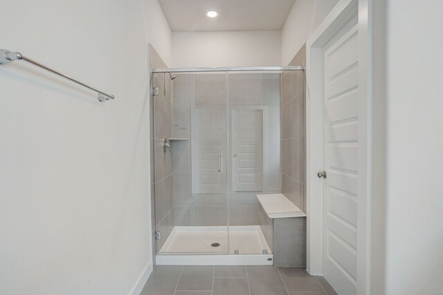 bathroom featuring tile patterned flooring and an enclosed shower