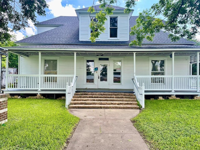 farmhouse-style home with covered porch and a front lawn