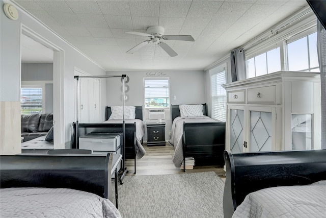 bedroom with ceiling fan and light hardwood / wood-style flooring