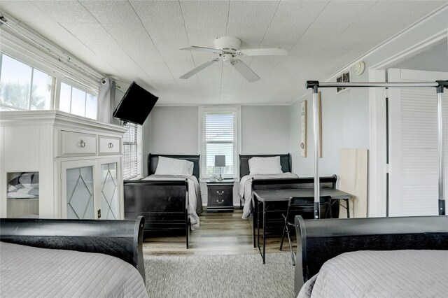 bedroom with wood-type flooring and ceiling fan