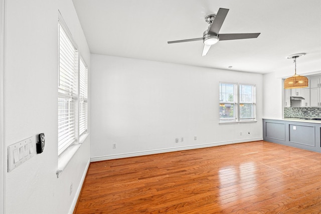 unfurnished living room with ceiling fan and light hardwood / wood-style floors