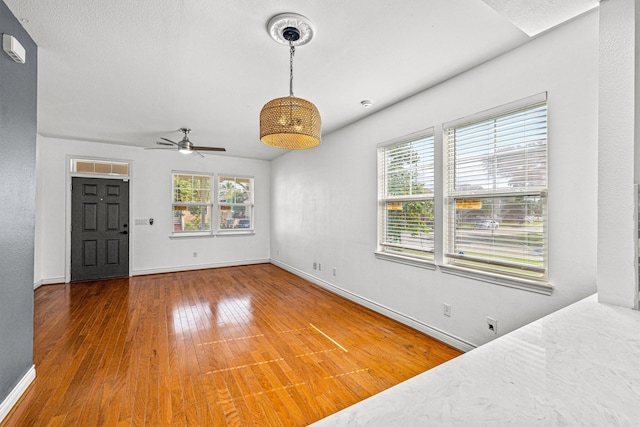 interior space with hardwood / wood-style flooring and ceiling fan