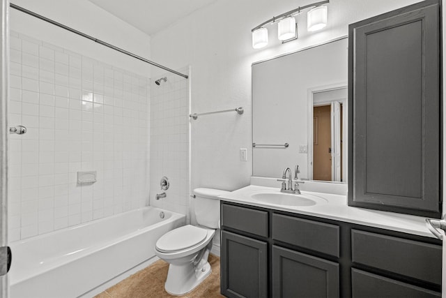 full bathroom featuring toilet, tile patterned flooring, tiled shower / bath, and vanity