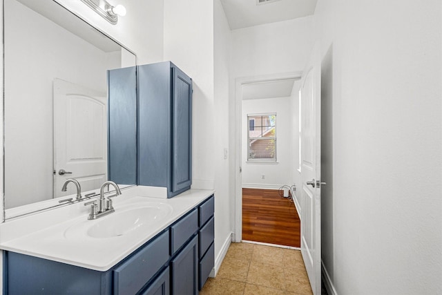 bathroom featuring tile patterned flooring and vanity