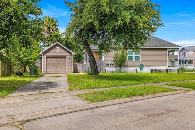 view of front of house with an outbuilding, a front yard, and a garage