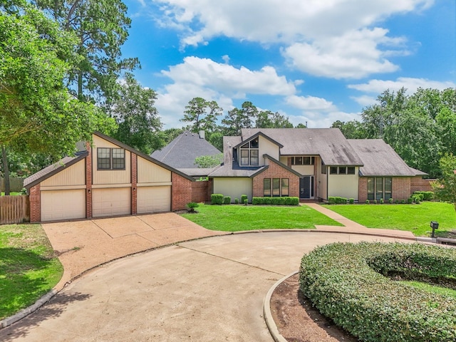 tudor house with a front yard and a garage