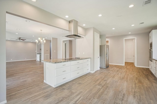 kitchen featuring hanging light fixtures, light stone counters, white cabinetry, island exhaust hood, and stainless steel appliances