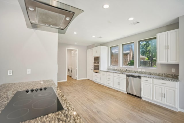 kitchen featuring black electric cooktop, white cabinets, stainless steel dishwasher, and light wood-type flooring