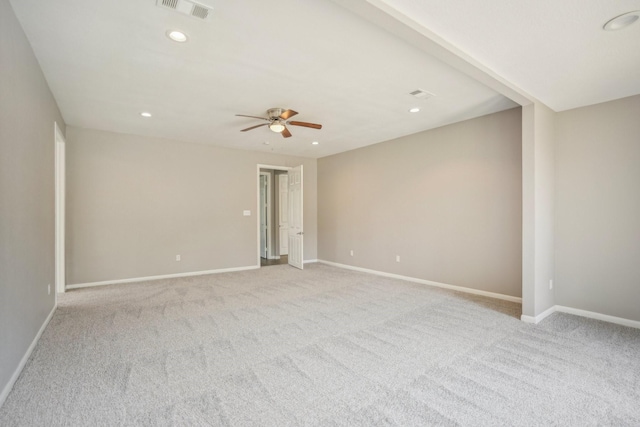 empty room with ceiling fan and light carpet