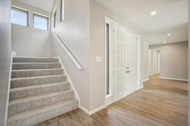 stairs with hardwood / wood-style floors