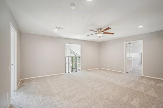 unfurnished room with light carpet and ceiling fan