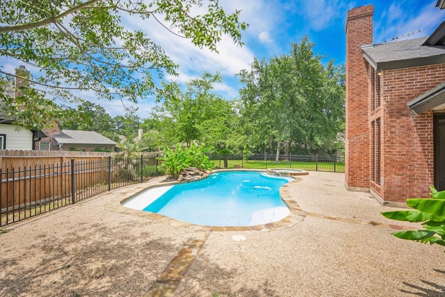 view of swimming pool with an in ground hot tub and a patio area