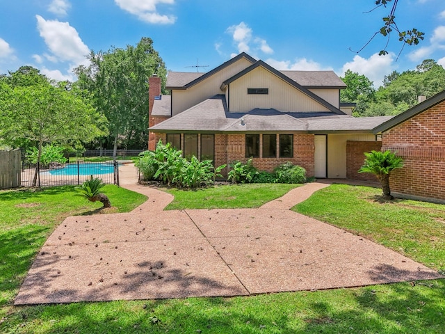 back of property featuring a lawn and a patio area