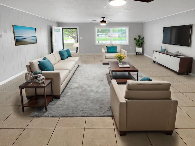 tiled living room featuring ceiling fan and wood walls