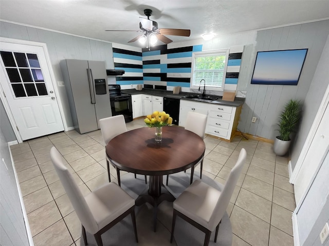 kitchen with black appliances, white cabinets, sink, and light tile patterned flooring